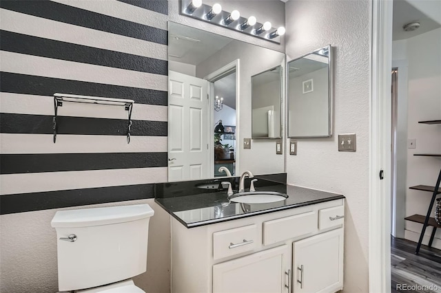 3252 E 103rd Dr Unit 708, Denver, CO 80229 - half bath with vanity, a textured wall, and wood finished floors