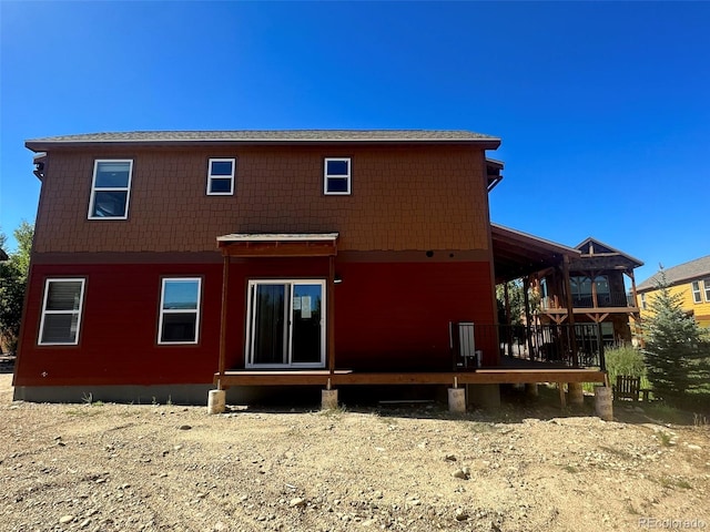 rear view of property featuring a deck