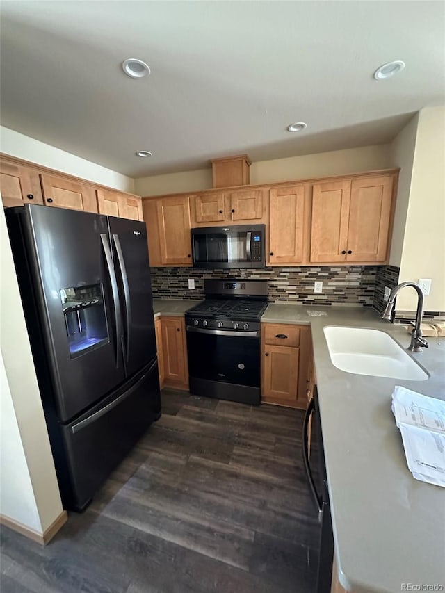 kitchen featuring sink, refrigerator with ice dispenser, dark hardwood / wood-style floors, dishwashing machine, and stainless steel stove