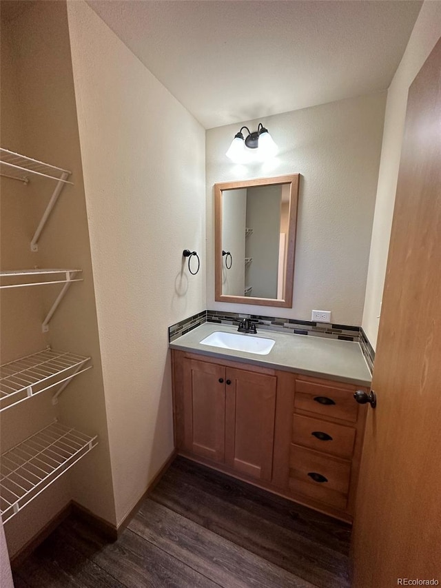 bathroom with vanity and wood-type flooring