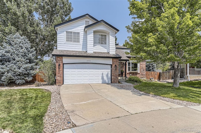 view of front of property with a garage and a front yard