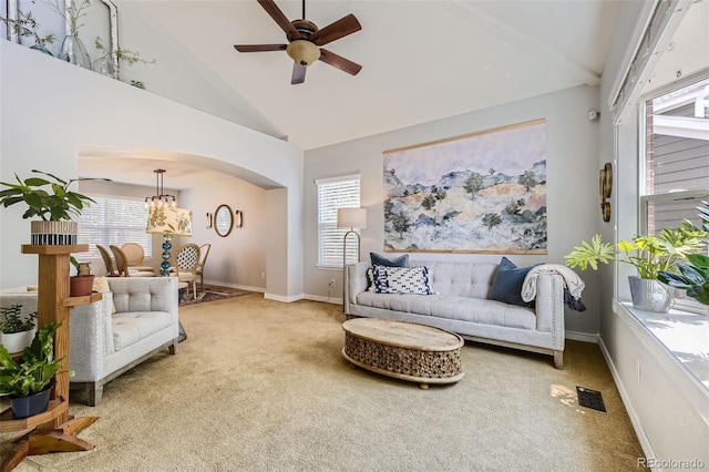 carpeted living room featuring ceiling fan and high vaulted ceiling