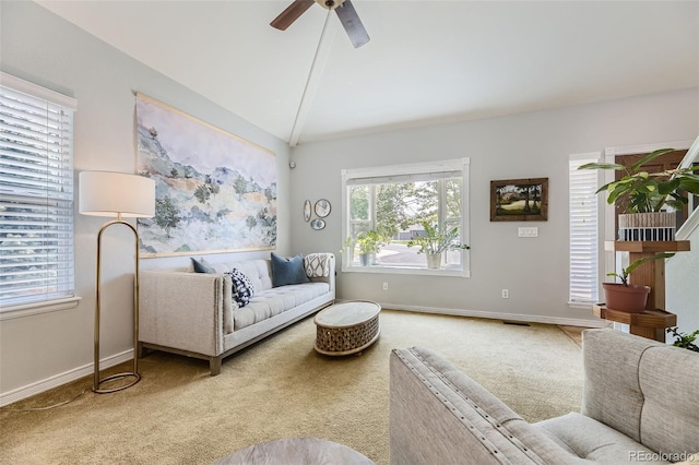 living room with ceiling fan, light colored carpet, and vaulted ceiling