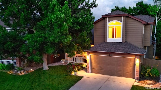 5150 Morning Glory Pl, Highlands Ranch, CO 80130 - view of front facade with driveway, roof with shingles, and an attached garage