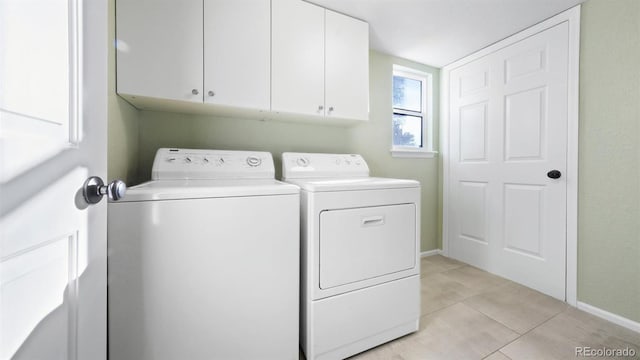 5150 Morning Glory Pl, Highlands Ranch, CO 80130 - laundry area with washer and clothes dryer, cabinet space, and light tile patterned floors
