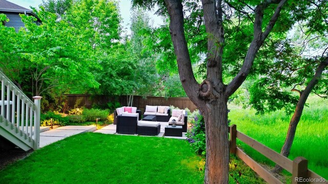 5150 Morning Glory Pl, Highlands Ranch, CO 80130 - fenced yard featuring an outdoor living space and a patio area