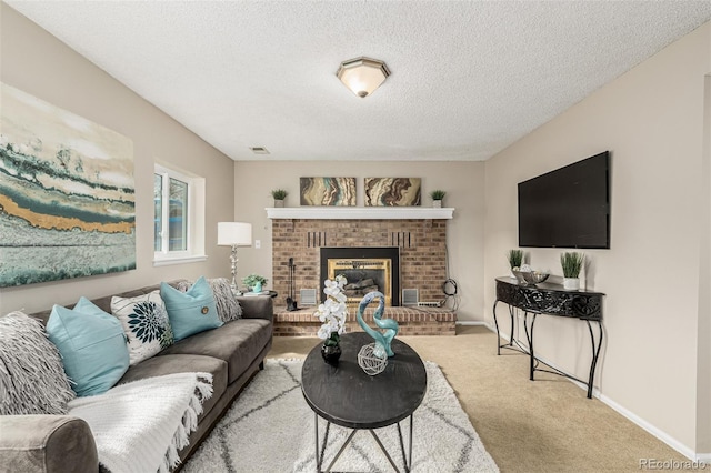 living area with carpet floors, a brick fireplace, a textured ceiling, and baseboards