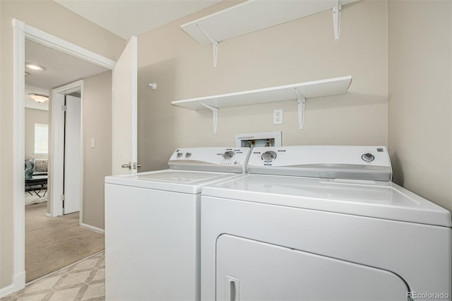 washroom featuring laundry area, light floors, washing machine and dryer, and baseboards