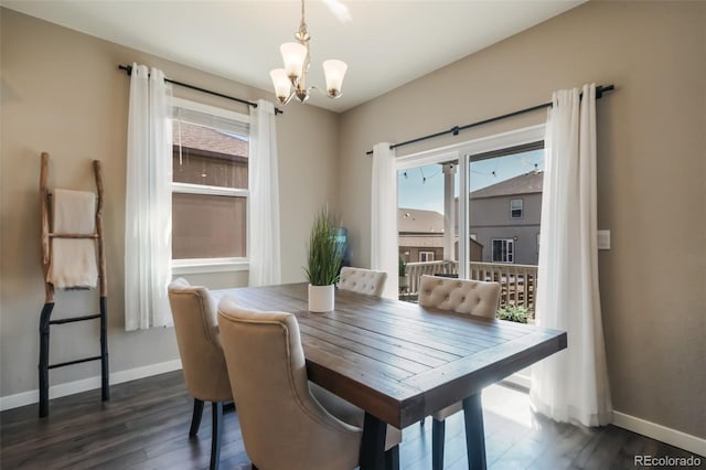 dining room featuring dark wood-type flooring, plenty of natural light, and baseboards