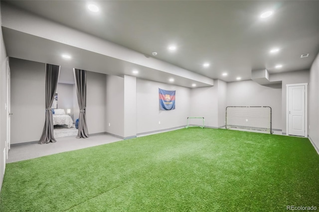 basement featuring recessed lighting, light carpet, visible vents, and baseboards