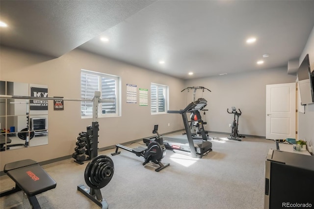 workout area featuring recessed lighting and baseboards