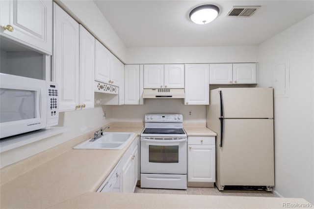 8463 Everett Way Unit B, Arvada, CO 80005 - kitchen with white appliances, under cabinet range hood, white cabinetry, light countertops, and light tile patterned floors