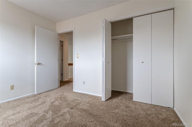 8463 Everett Way Unit B, Arvada, CO 80005 - unfurnished bedroom featuring carpet flooring, a closet, and a textured ceiling