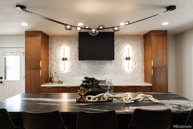 30938 Niakwa Rd, Evergreen, CO 80439 - bar area with decorative backsplash, recessed lighting, and a textured ceiling