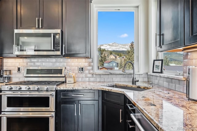 255 Flannigan Cir, Alma, CO 80420 - kitchen with appliances with stainless steel finishes, a mountain view, a sink, and tasteful backsplash