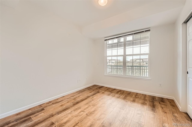 empty room with light wood-style flooring and baseboards
