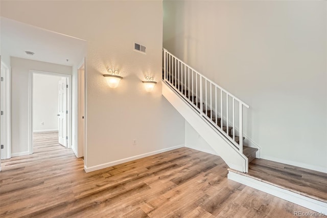 staircase with wood finished floors and baseboards