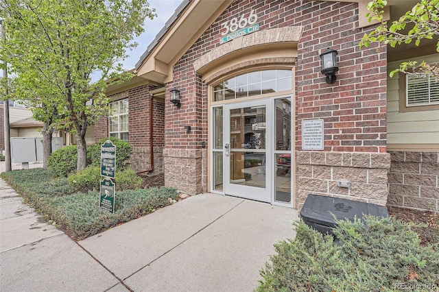 property entrance featuring brick siding