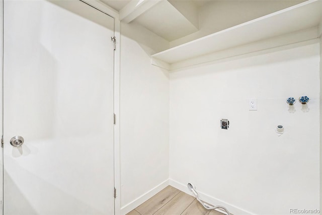 clothes washing area with electric dryer hookup, hookup for a washing machine, and light wood-type flooring