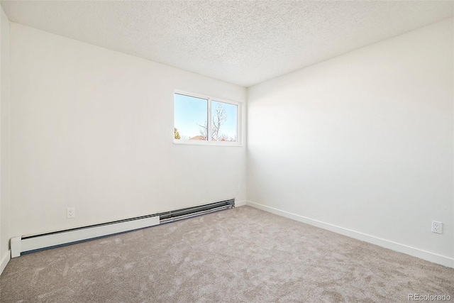 carpeted empty room with a baseboard heating unit and a textured ceiling