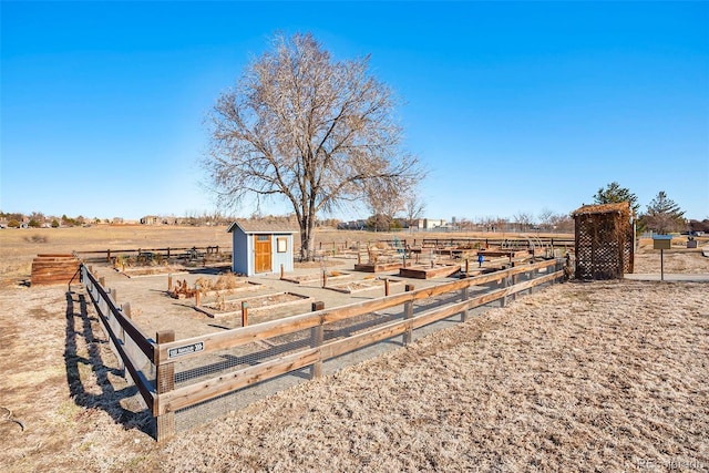 view of yard with a rural view and a storage shed