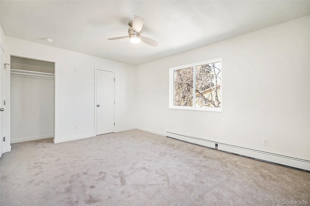 unfurnished bedroom with a baseboard radiator, light colored carpet, a closet, and ceiling fan