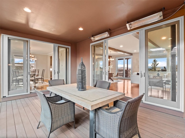 wooden deck featuring a chandelier and french doors