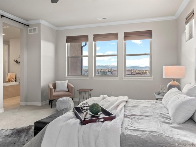 bedroom with a barn door, crown molding, and carpet