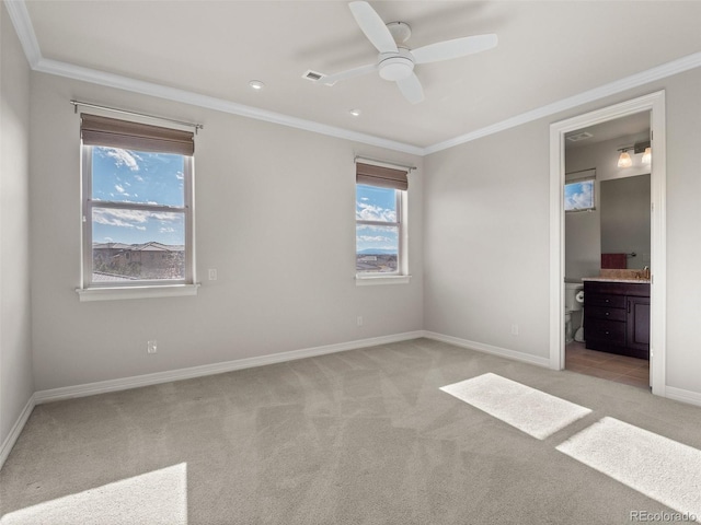 unfurnished bedroom featuring ensuite bath, crown molding, and light colored carpet