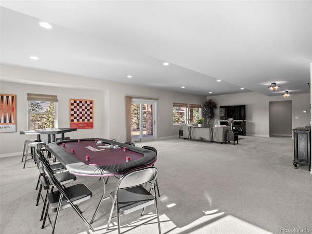 game room featuring a wealth of natural light and light colored carpet