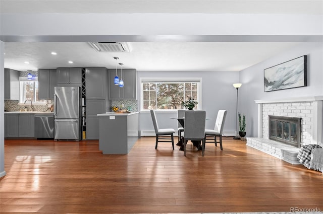 dining space with sink, dark hardwood / wood-style floors, and a wealth of natural light