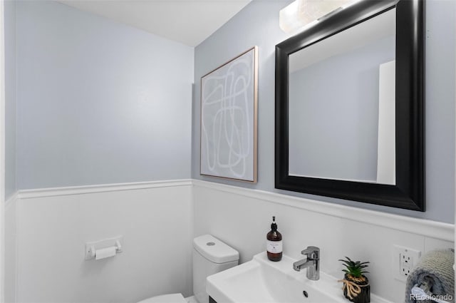 bathroom featuring sink and toilet