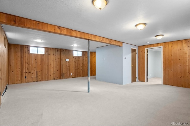 basement featuring light carpet