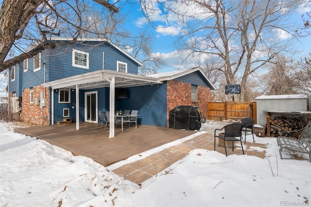 snow covered property featuring a deck