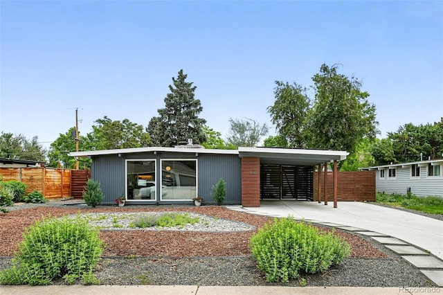 1440 S Clermont St, Denver, CO 80222 - view of front facade featuring driveway and an attached carport
