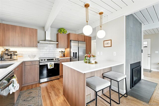 1440 S Clermont St, Denver, CO 80222 - kitchen featuring stainless steel appliances, wall chimney range hood, a breakfast bar area, light wood-style flooring, and wood ceiling with exposed beams