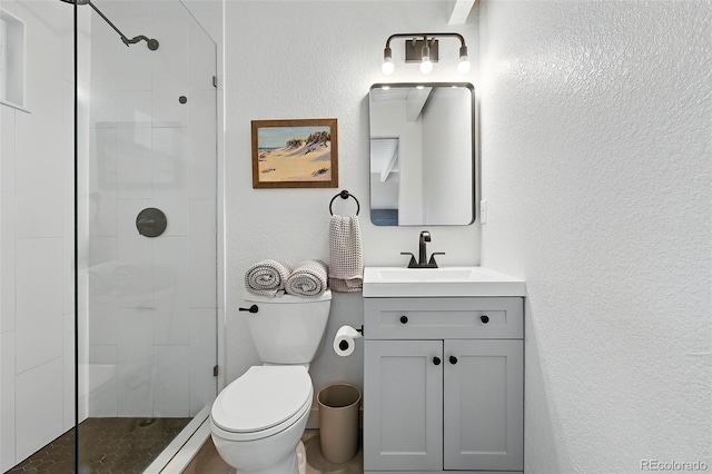 1440 S Clermont St, Denver, CO 80222 - full bath featuring toilet, a tile shower, vanity, and a textured wall