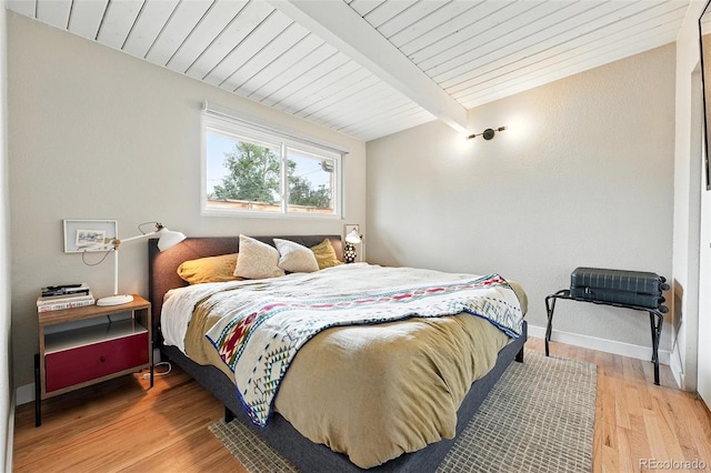 1440 S Clermont St, Denver, CO 80222 - bedroom with light wood finished floors, wooden ceiling with exposed beams, and baseboards