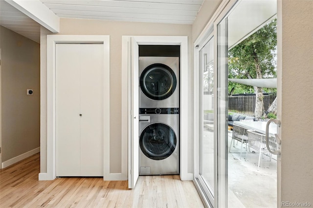 1440 S Clermont St, Denver, CO 80222 - washroom featuring stacked washing machine and dryer, healthy amount of natural light, light wood-type flooring, baseboards, and wooden ceiling
