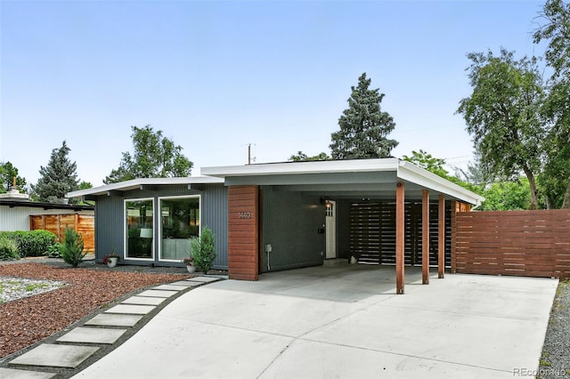 1440 S Clermont St, Denver, CO 80222 - view of front facade with concrete driveway and a carport