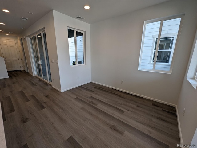 empty room with dark wood-type flooring