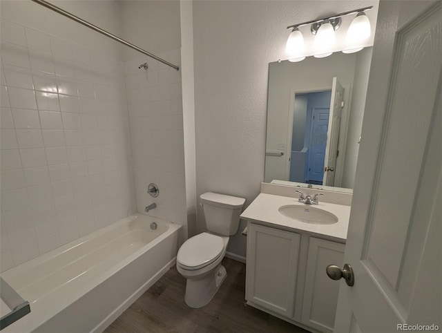 full bathroom featuring shower / tub combination, vanity, wood-type flooring, and toilet