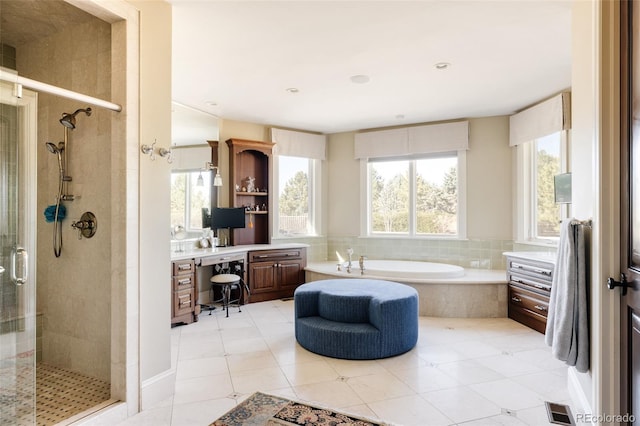 bathroom with a stall shower, tile patterned floors, a bath, visible vents, and vanity
