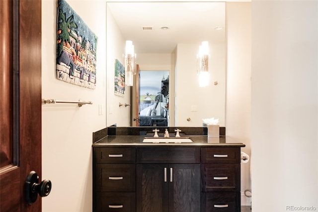 ensuite bathroom with vanity, ensuite bathroom, and visible vents