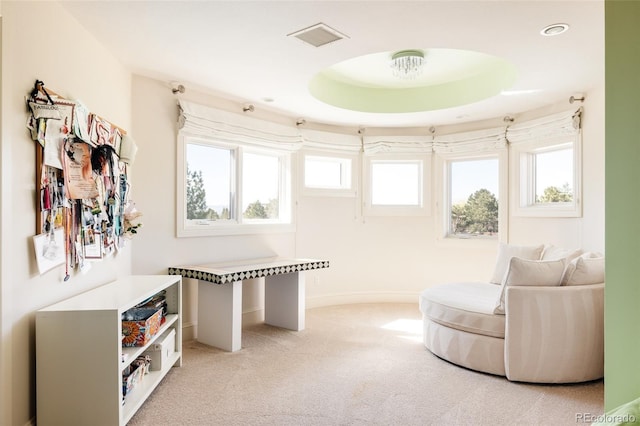 sitting room with light carpet, a wealth of natural light, baseboards, and visible vents
