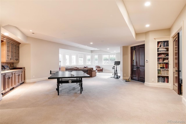 recreation room with light carpet, baseboards, and recessed lighting