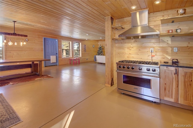 1245 Blossom Rd, Woodland Park, CO 80863 - kitchen with light brown cabinets, ventilation hood, decorative light fixtures, wooden walls, and high end range