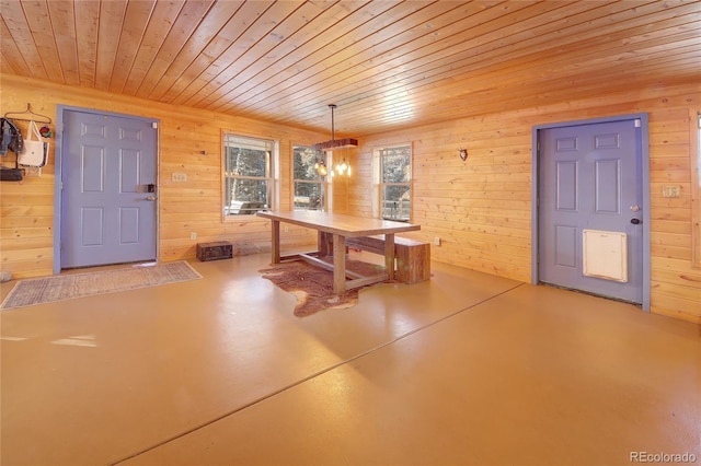 1245 Blossom Rd, Woodland Park, CO 80863 - unfurnished dining area with concrete flooring, wooden walls, an inviting chandelier, and wooden ceiling