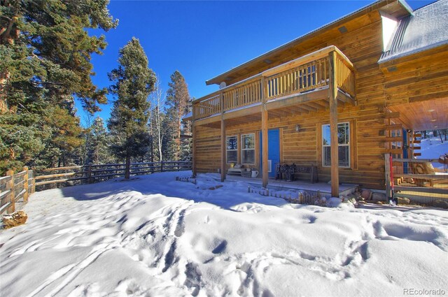 1245 Blossom Rd, Woodland Park, CO 80863 - snow covered property with a balcony