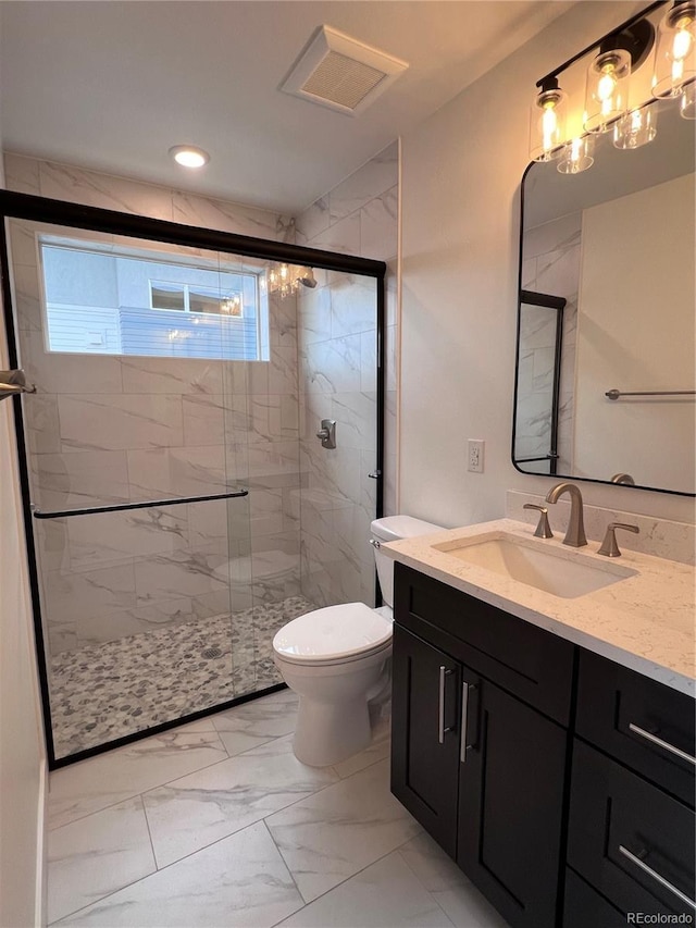 bathroom featuring vanity, toilet, and walk in shower